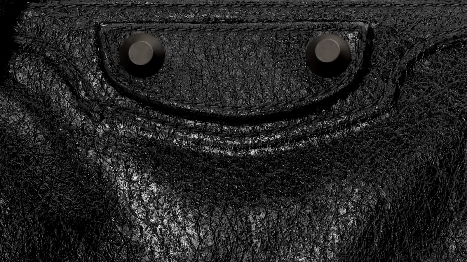 Flap and studs of the City bag in close-up, still from the CGI film